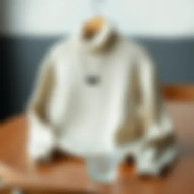 Stylish high-neck sweater on a wooden table