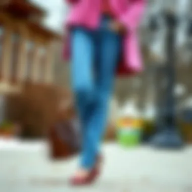 Fashionable ensemble featuring blue jeans and a pink coat against a seasonal backdrop