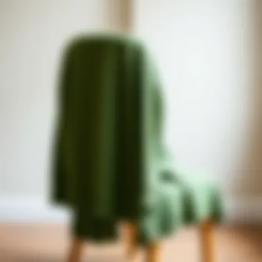 Elegant green cardigan draped over a chair showcasing its texture