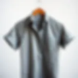 A stylish gray shirt draped elegantly on a minimalist backdrop
