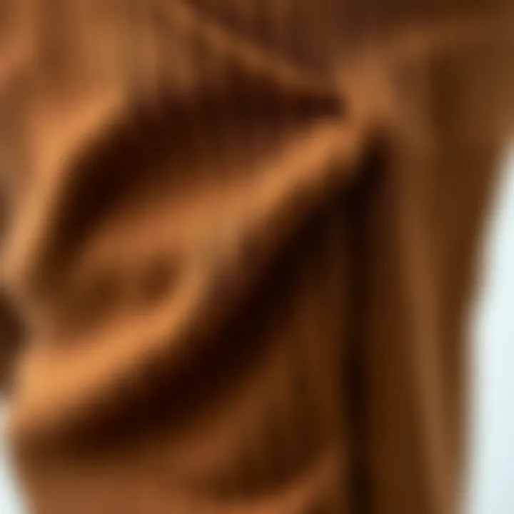 Close-up of fabric texture of brown knit trousers.
