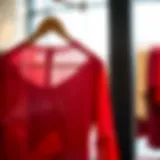 A vibrant red tunic displayed on a hanger showcasing elegant design.