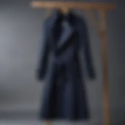 Classic navy trench coat hanging elegantly on a wooden hanger