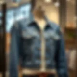 A stylish blue denim jacket displayed on a mannequin