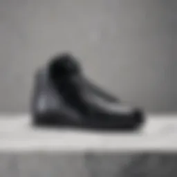 Sleek silhouette of black Nike shoes on a marble surface