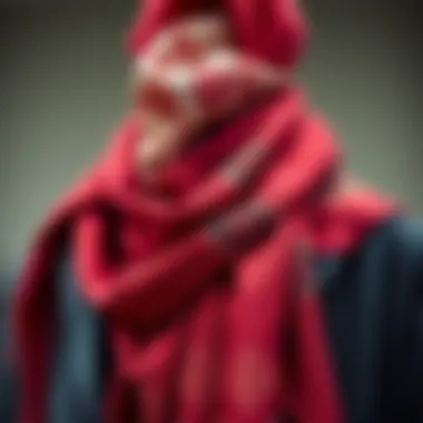 Elegant red scarf with intricate patterns draped over a stylish coat