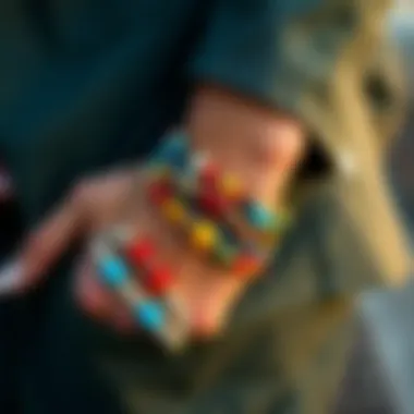 A stylish individual layering multiple colorful bead bracelets